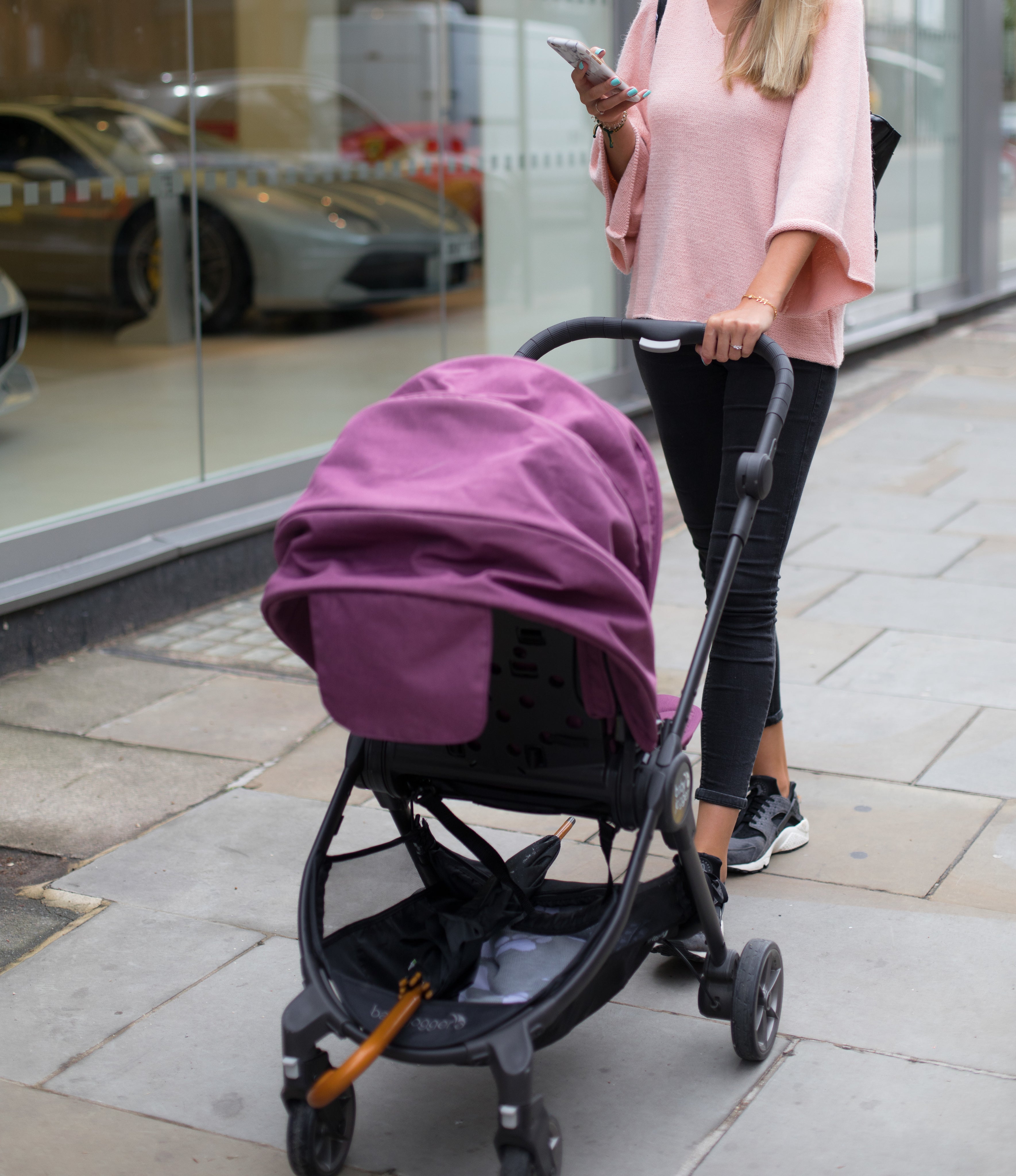 woman-pushes-stroller-while-using-phone.jpg